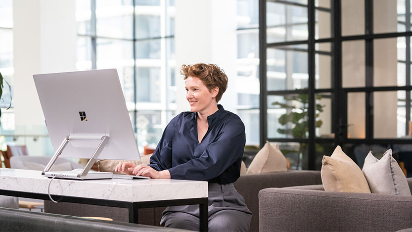 Woman working on a desktop computer.