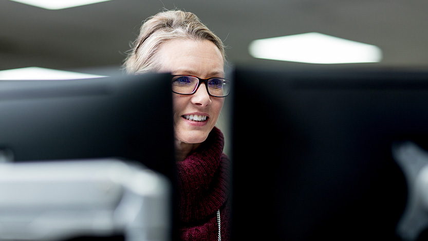 Person using two desktop monitors.